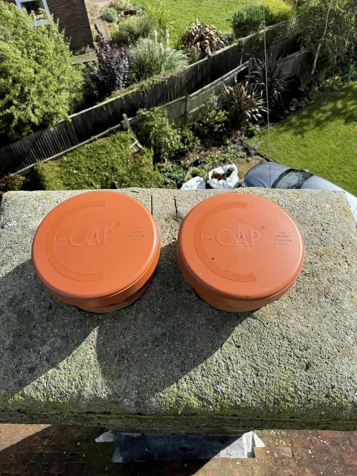 Two terracotta caps fitted to a capped-off chimney stack