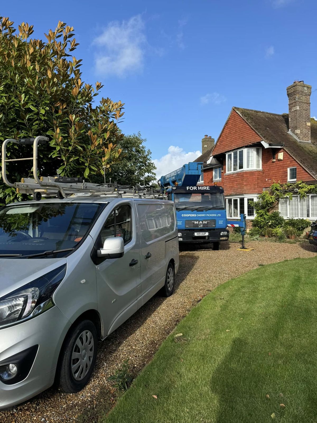 Van and access platform parked on a gravel driveway