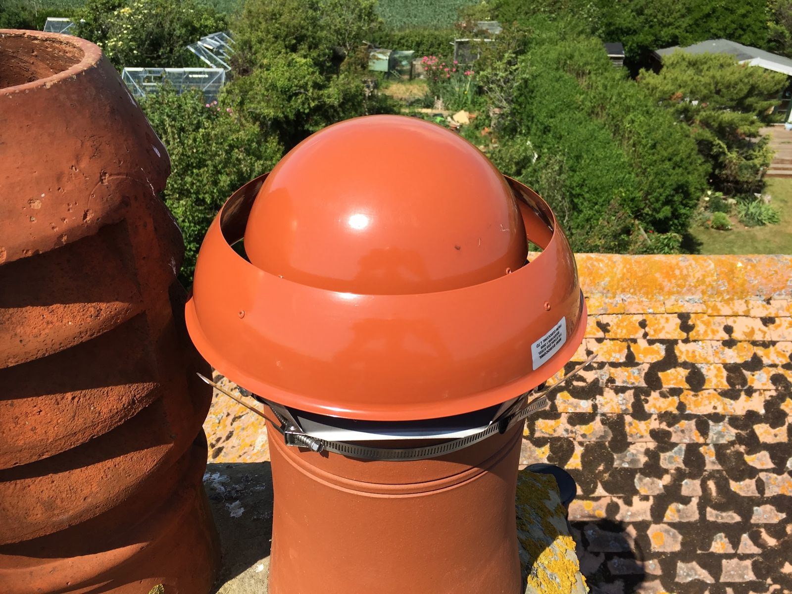 Terracotta dome cowl fitted to a chimney pot